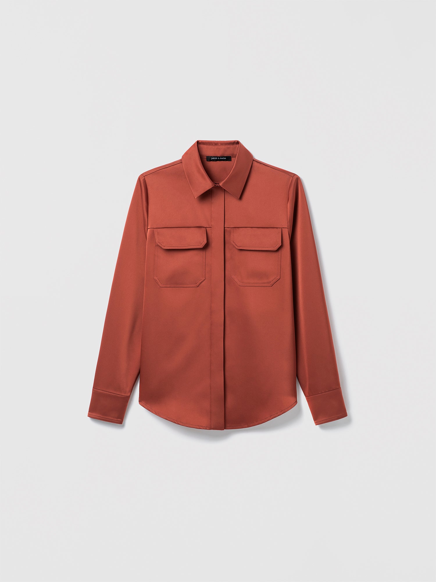 Terracotta long-sleeve button-up blouse with pointed collar and two front flap chest pockets, displayed flat against a white background.