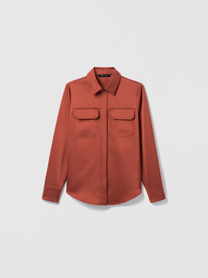 Terracotta long-sleeve button-up blouse with pointed collar and two front flap chest pockets, displayed flat against a white background.