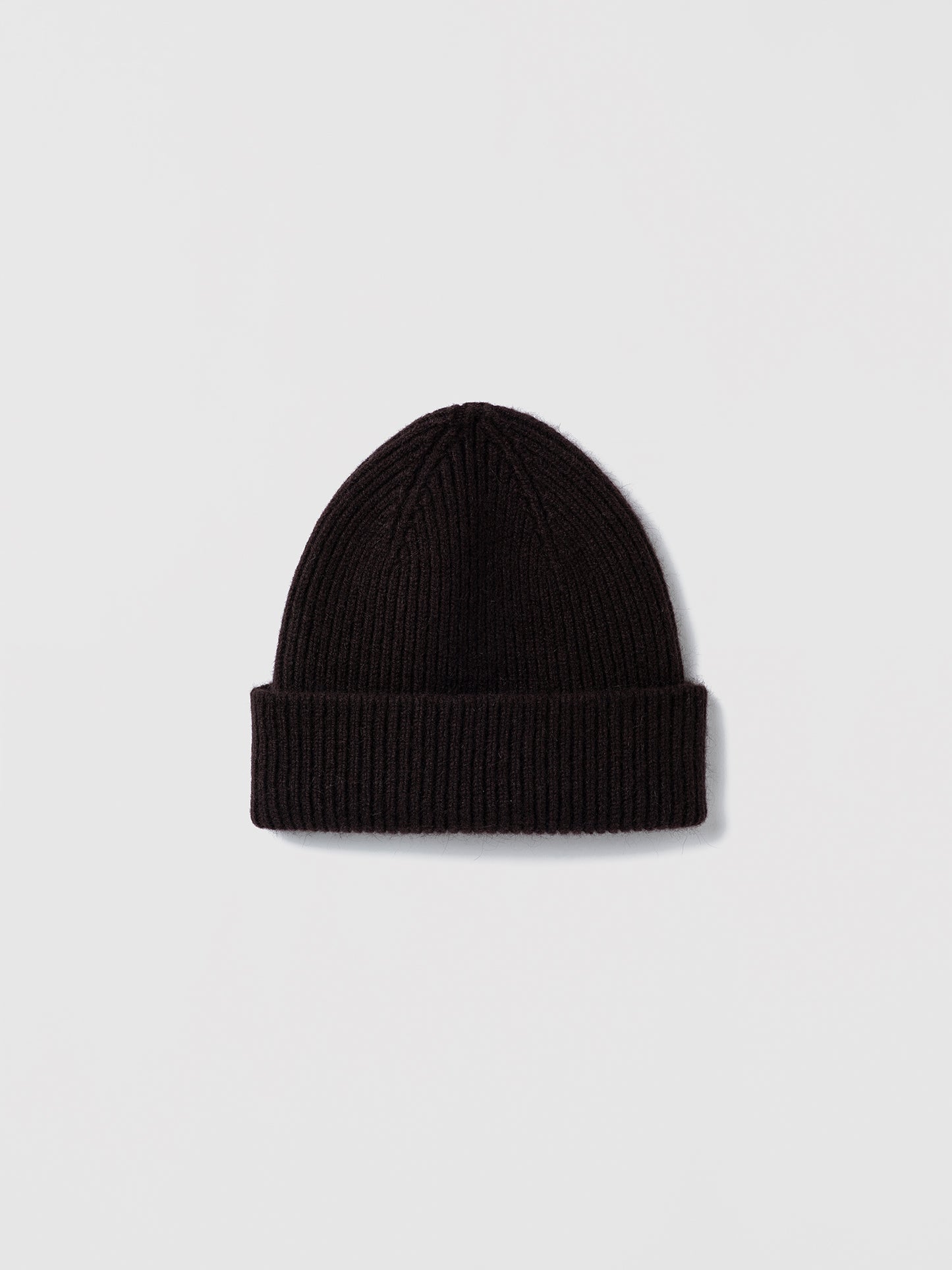 Flat lay of ribbed espresso beanie in soft lambswool and Caregora blend, classic silhouette in wool knit, made in Scotland
