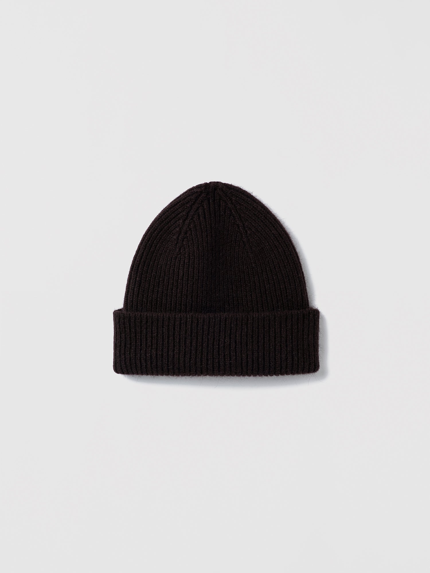 Flat lay of ribbed espresso beanie in soft lambswool and Caregora blend, classic silhouette in wool knit, made in Scotland