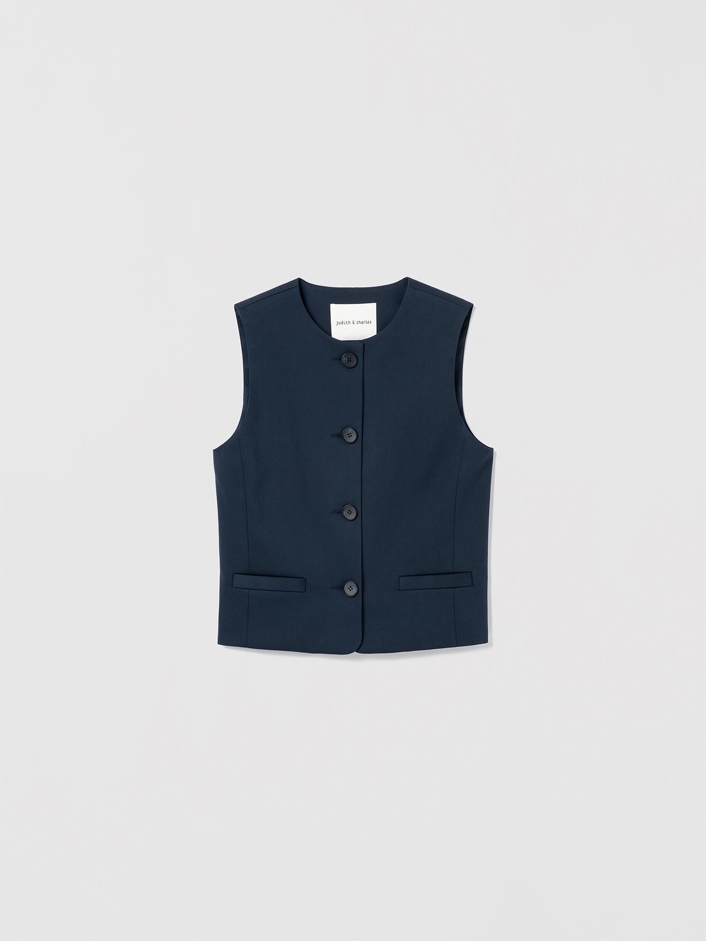 Navy blue vest with buttons on a light gray background