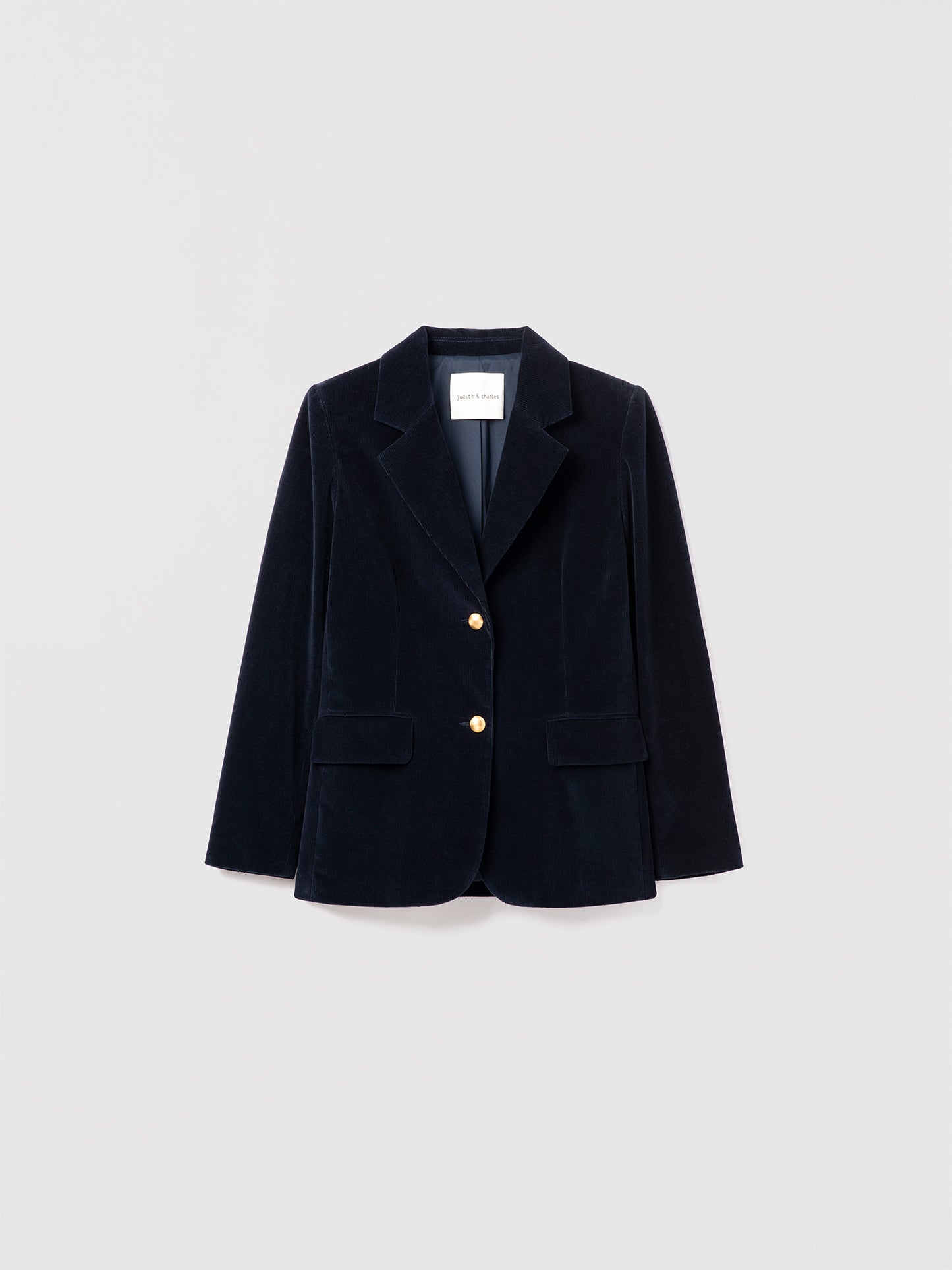 Judith & Charles navy stretch corduroy jacket with notch lapel, gold button closure, front flap pockets, and sleeve vents. Fully lined.