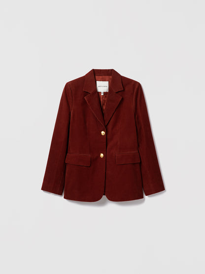 Judith & Charles rust stretch corduroy jacket with notch lapel, gold button closure, front flap pockets, and sleeve vents. Fully lined.