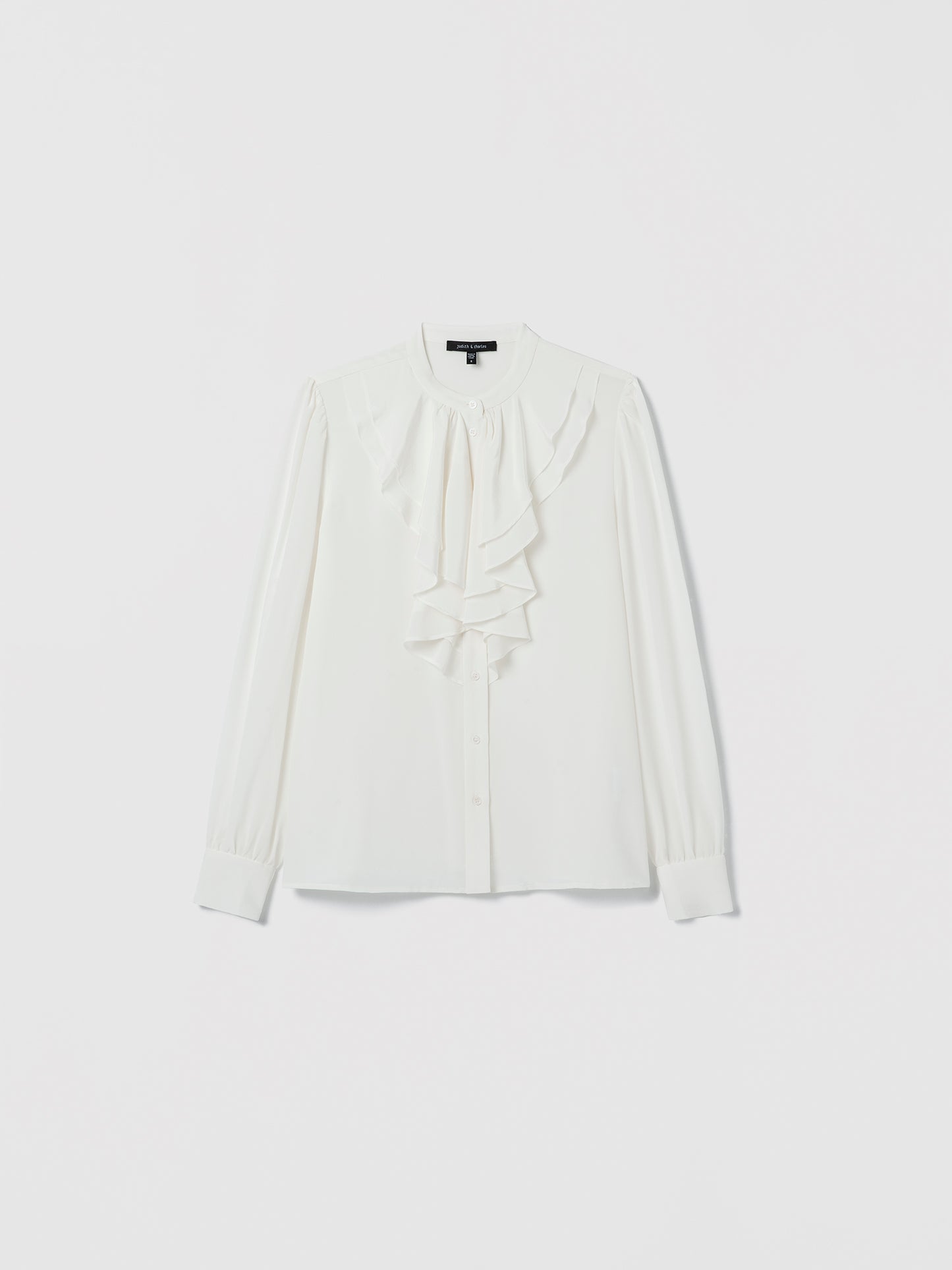 Off White blouse with a bow detail on a light gray background