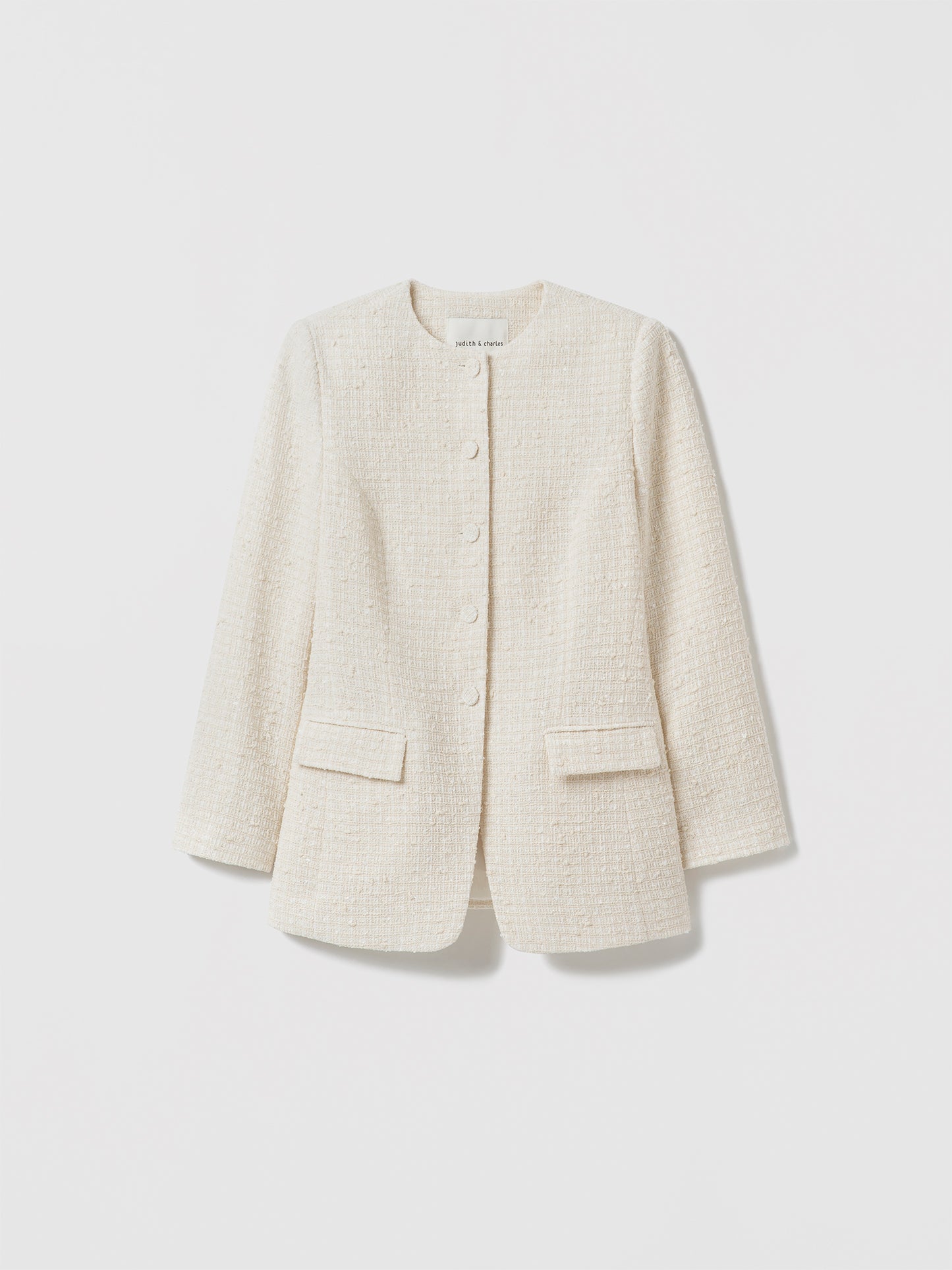 Cream textured tweed blazer with a round collar, button‑front closure, long sleeves, and two front flap pockets displayed on a white background.