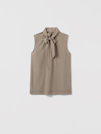 Camel sleeveless top with a removable bow detail on a white background