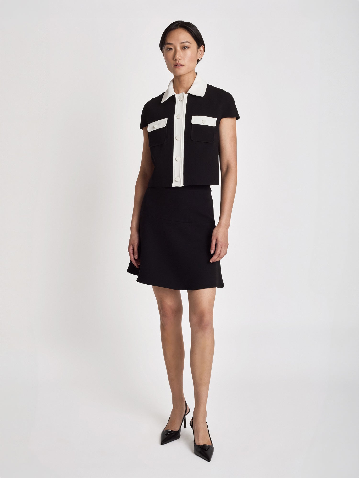 Judith and Charles Matera crop jacket in stretch crepe with cap sleeves, sharp tailoring, high-contrast trim, and a chest pocket, made in Canada (Style 600-1979)