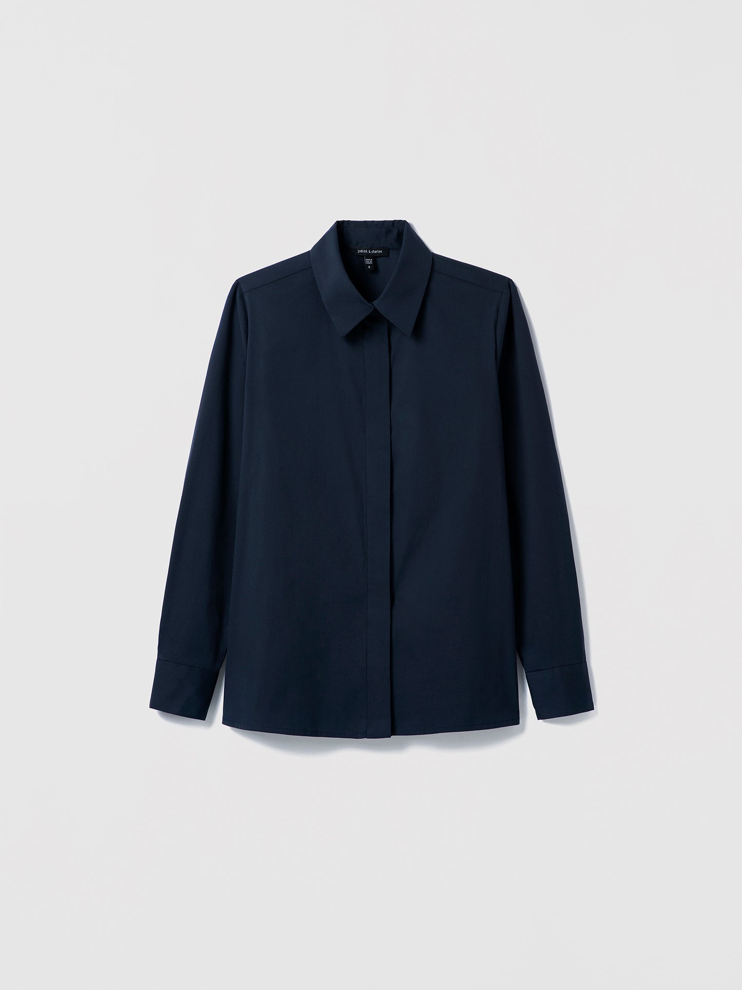 Navy Cotton‑blend blouse with spread collar and hidden button placket shown in a clean, structured silhouette