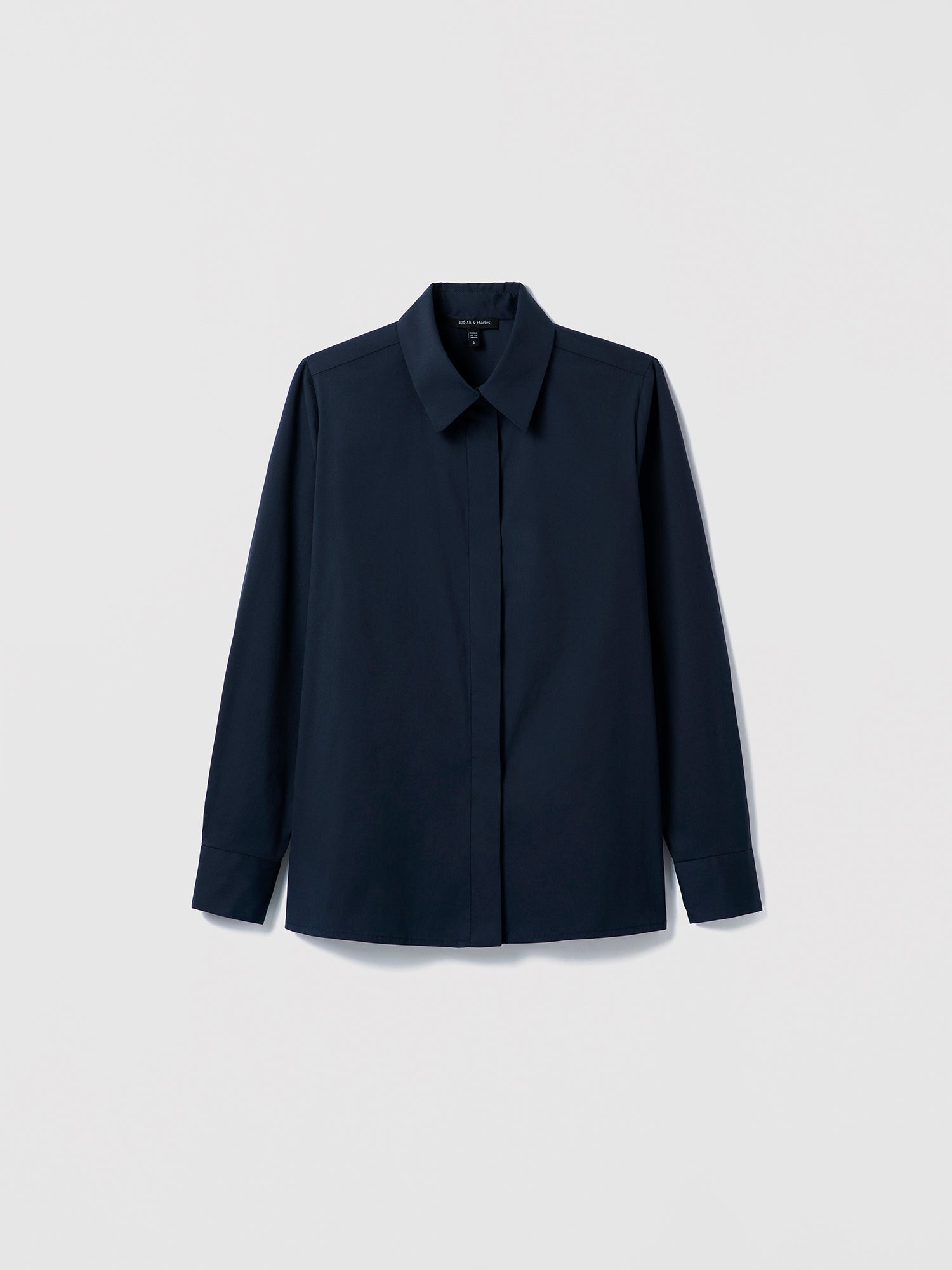 Navy Cotton‑blend blouse with spread collar and hidden button placket shown in a clean, structured silhouette