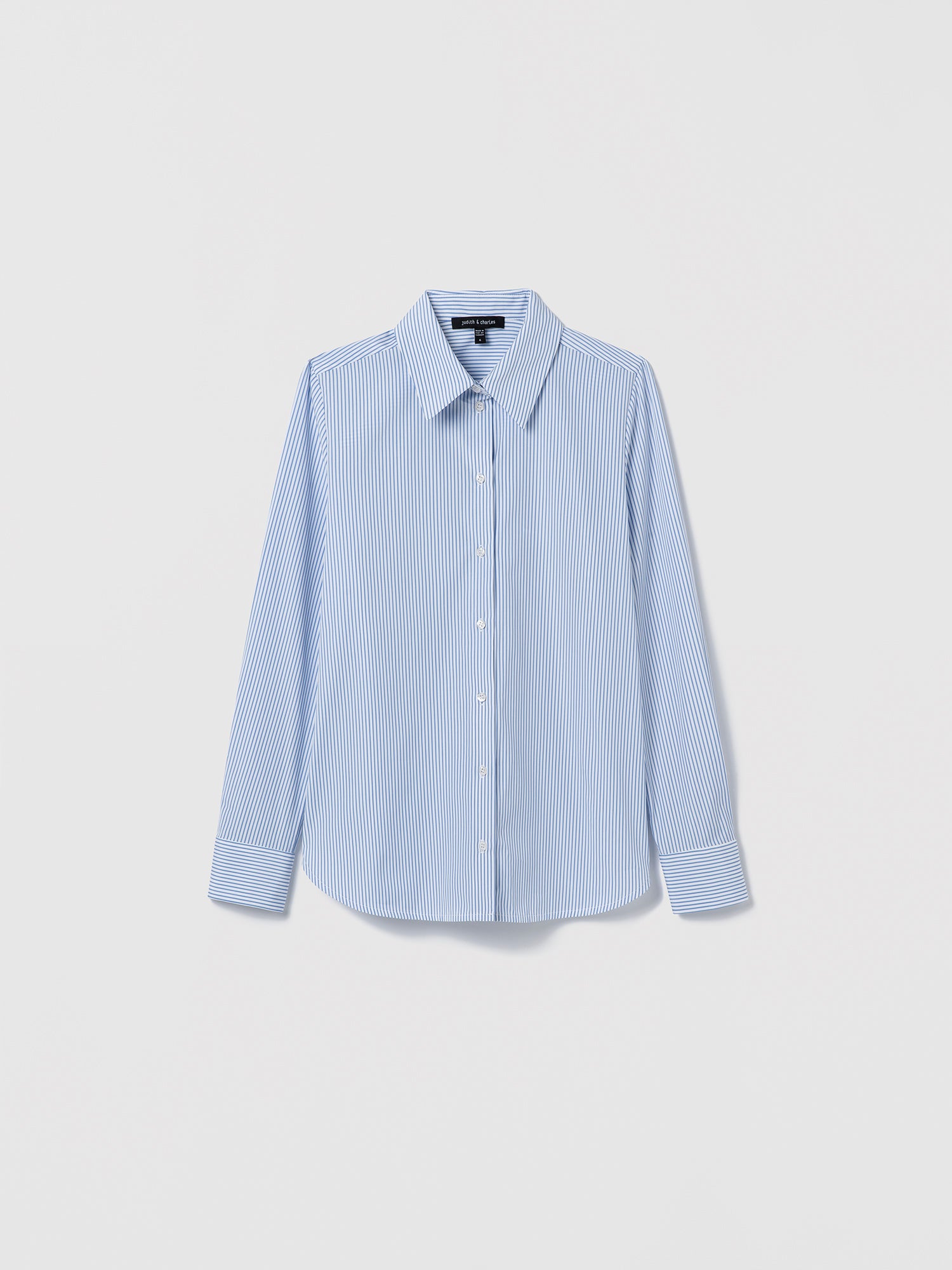 Flat-lay of a blue striped cotton poplin shirt with long sleeves, spread collar, and button closure