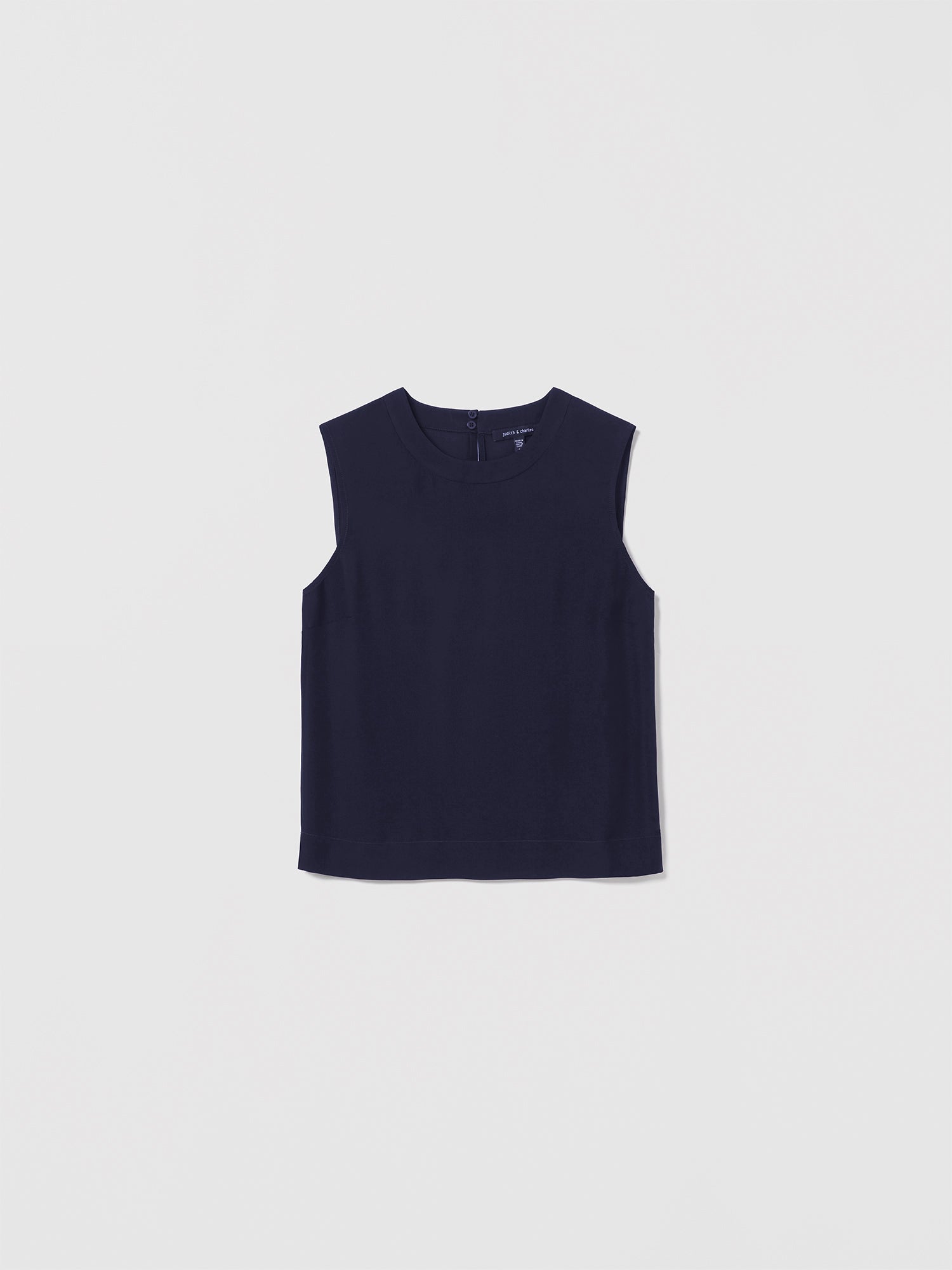 Judith & Charles navy sleeveless silk blouse with crew neck and back keyhole closure.