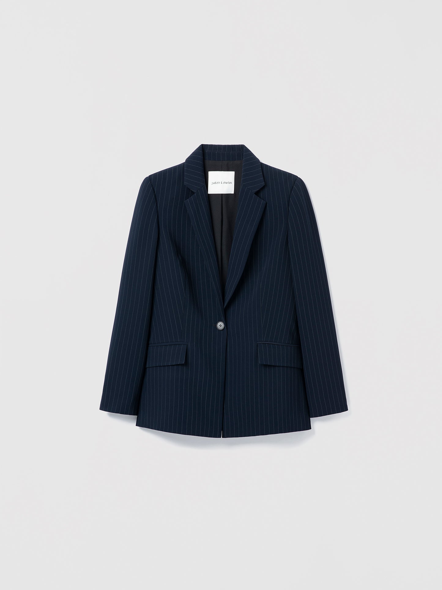 Navy pinstripe blazer on a light gray background