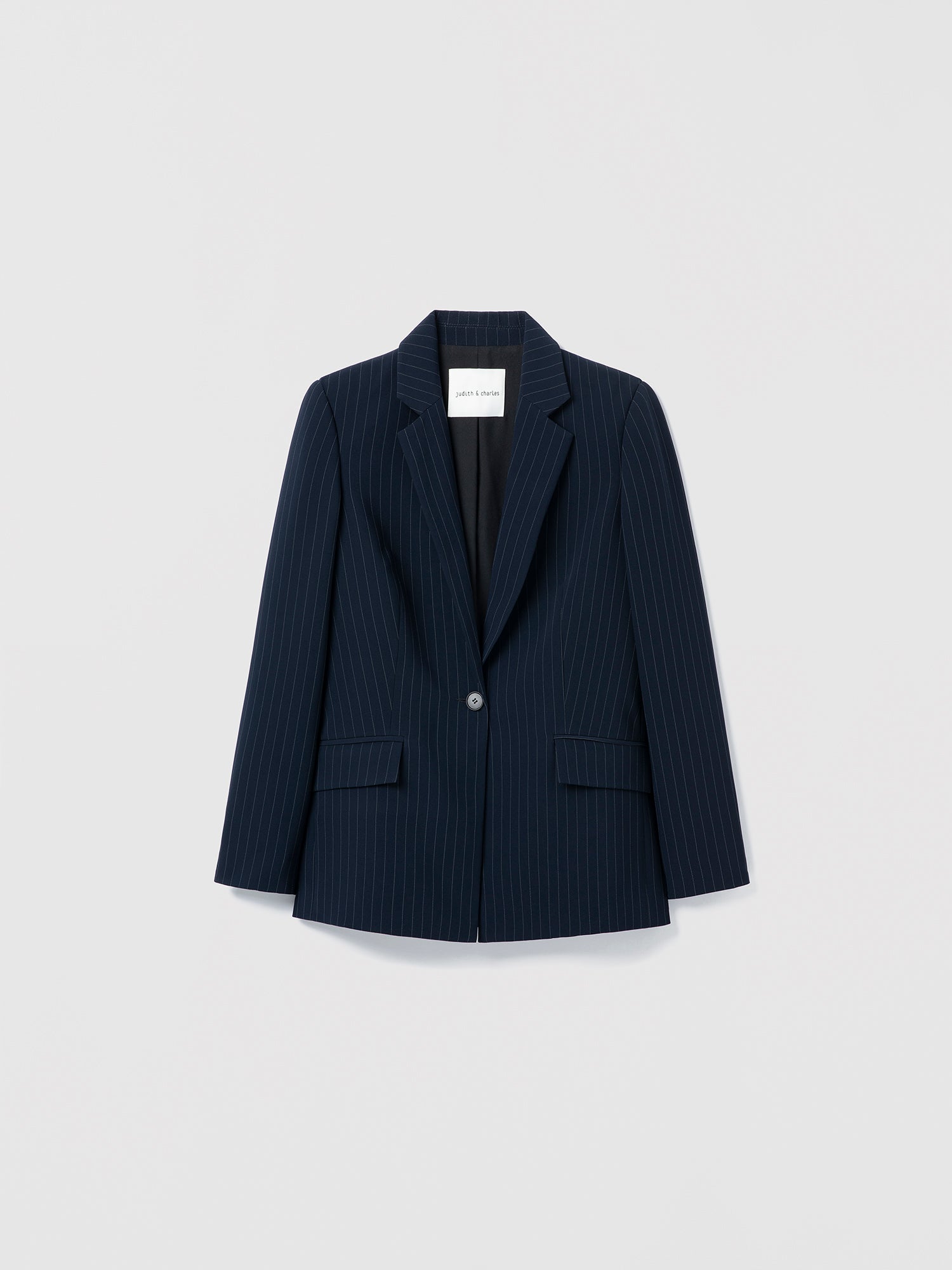 Navy pinstripe blazer on a light gray background