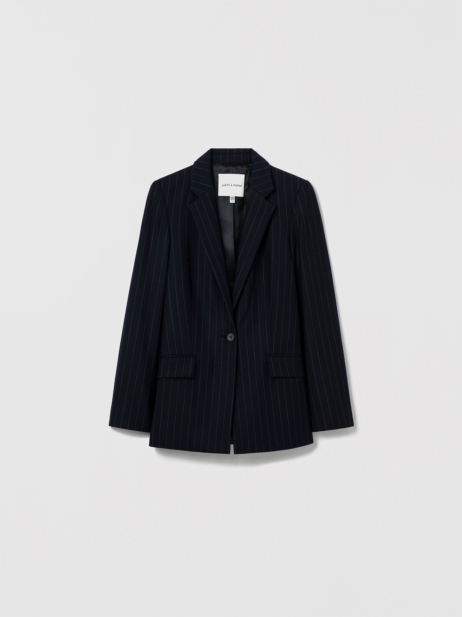 Judith & Charles navy pinstripe single-breasted blazer with notch lapel and button closure, made in Canada from virgin wool blend and fully lined in viscose.