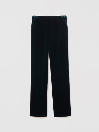 Emerad velvet pants on a light gray background