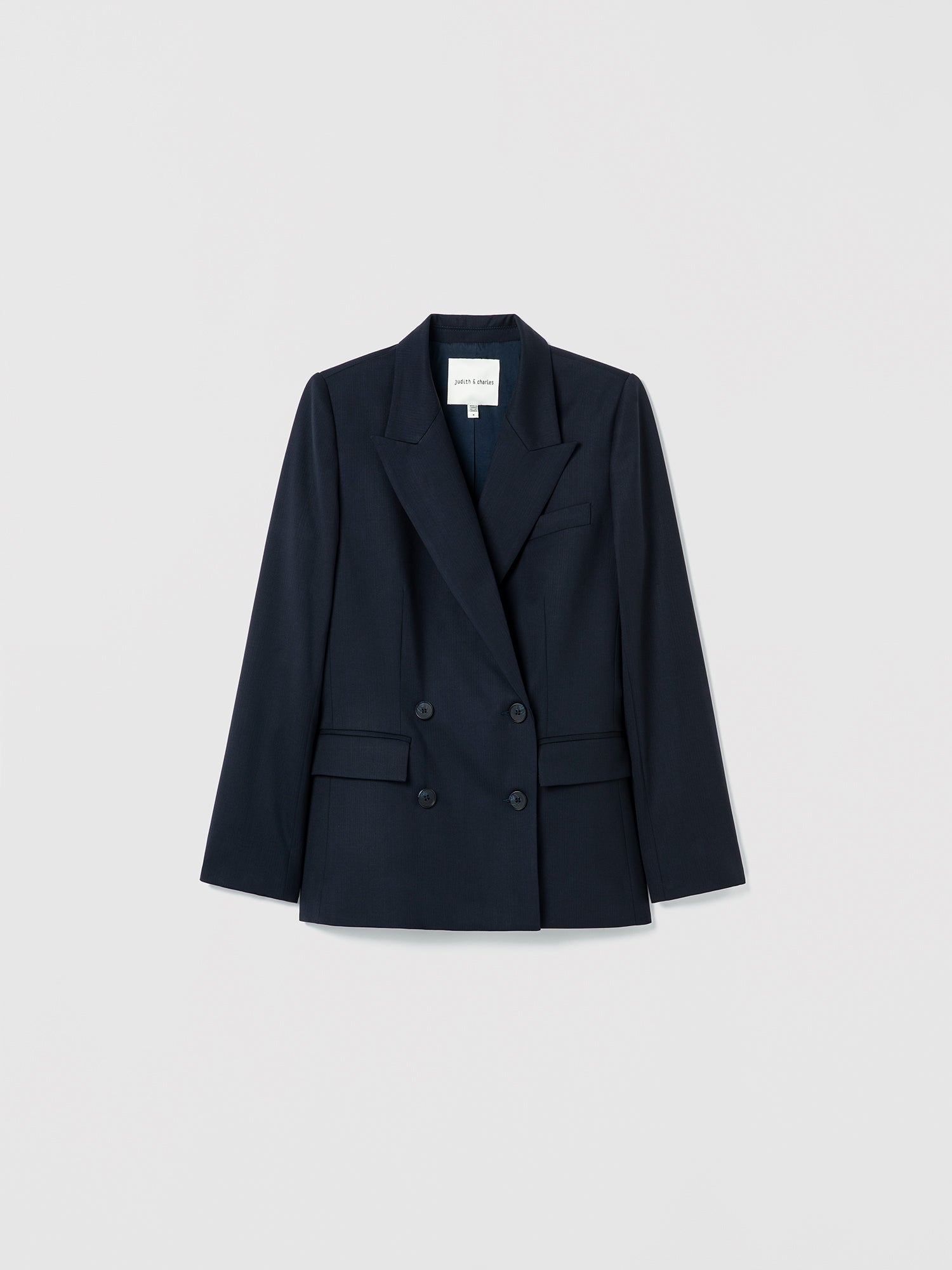 Navy blazer on a light gray background