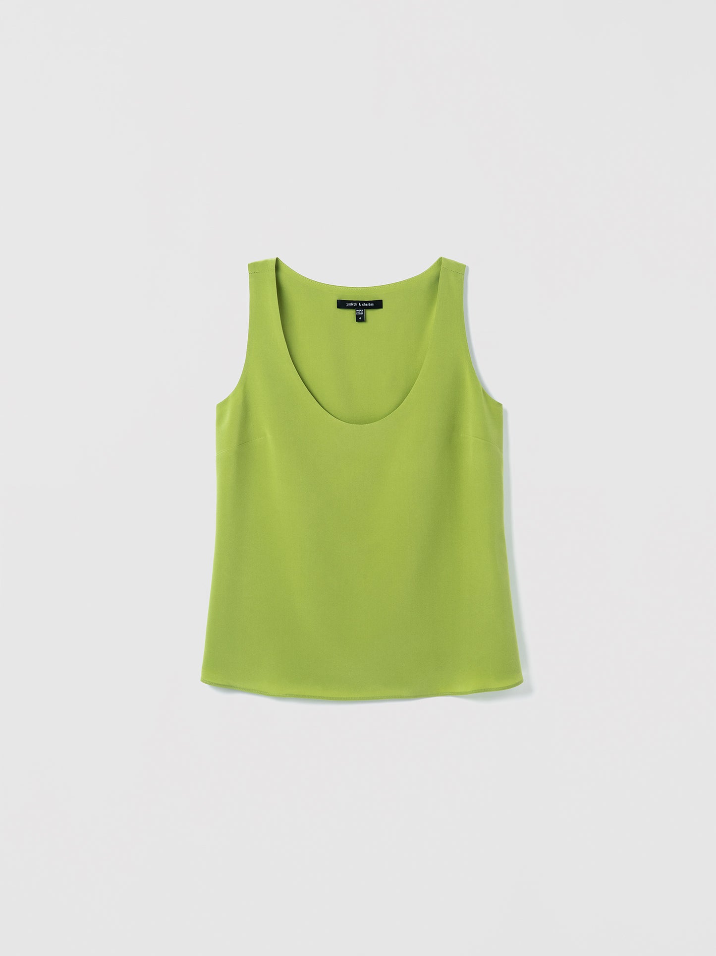 Flat of a clean scoop‑neck tank in silk, doubled in self fabric for a smooth, structured finish
