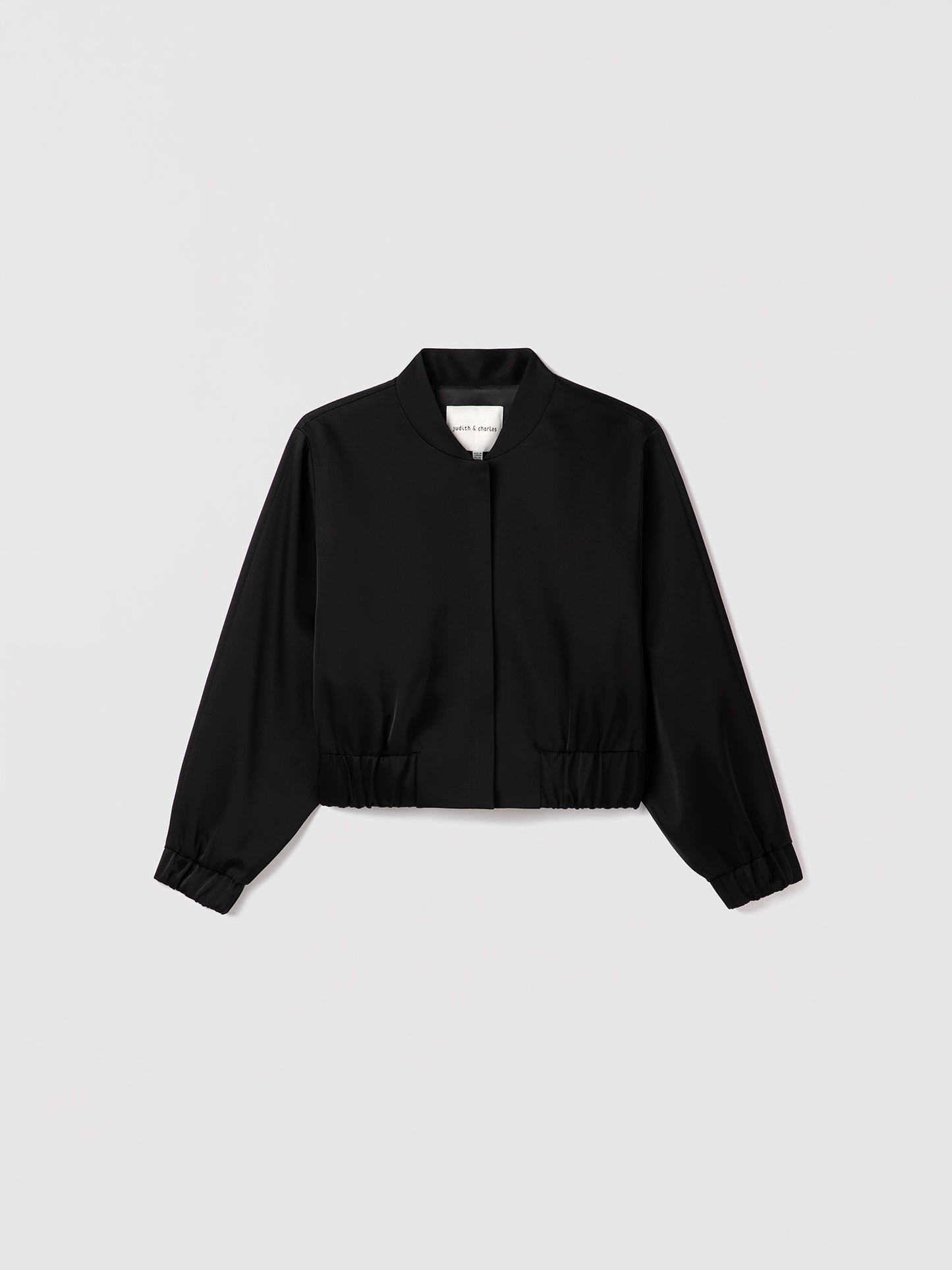 Black zipper jacket on a light gray background