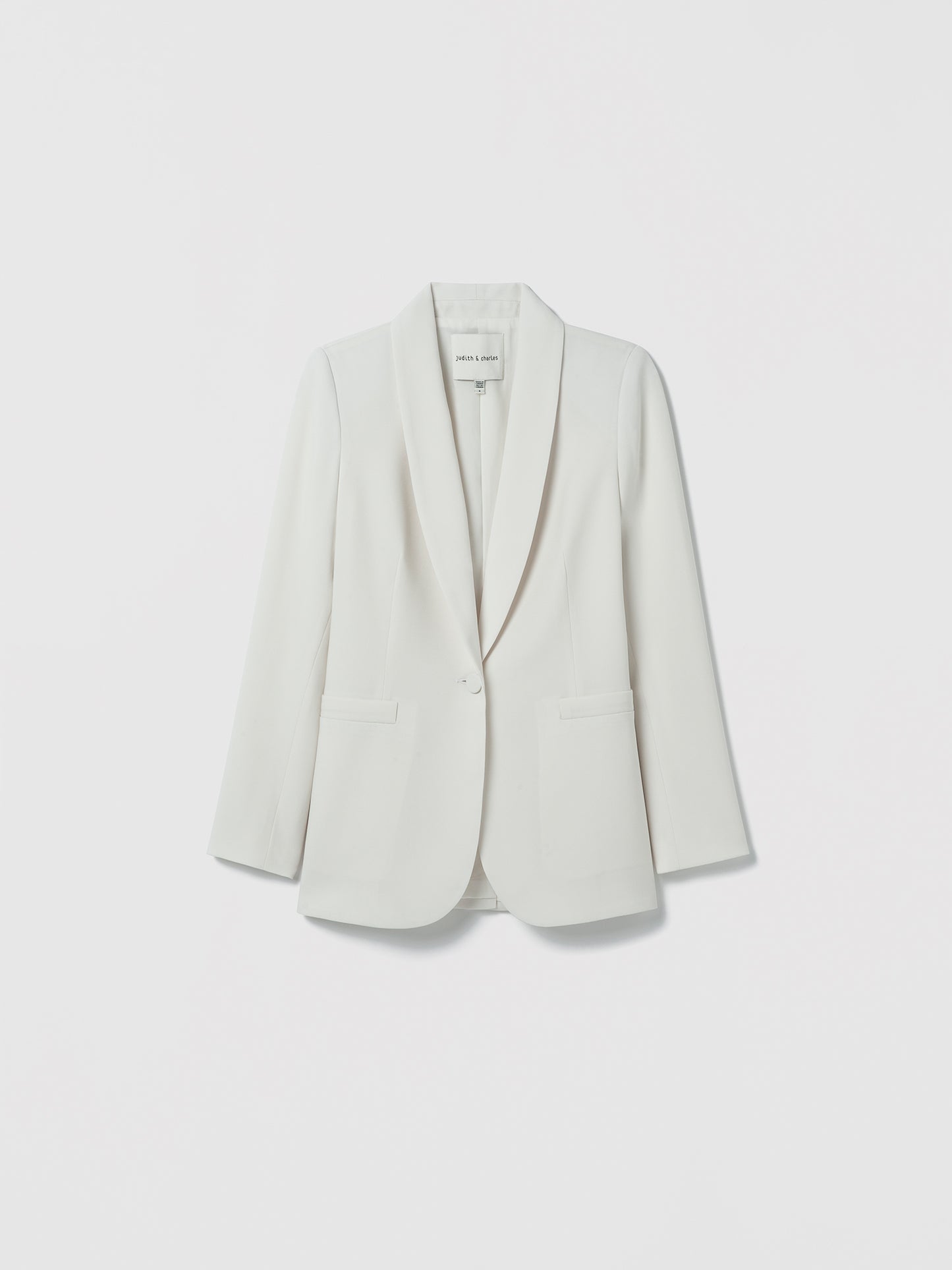 Flatshot of jacket in satin back crepe with a clean, easy fit. Finished with welt pockets, a self‑covered button, and a single back vent