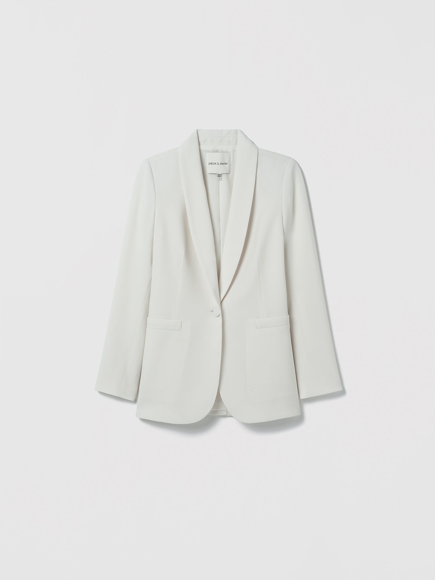 Flatshot of jacket in satin back crepe with a clean, easy fit. Finished with welt pockets, a self‑covered button, and a single back vent