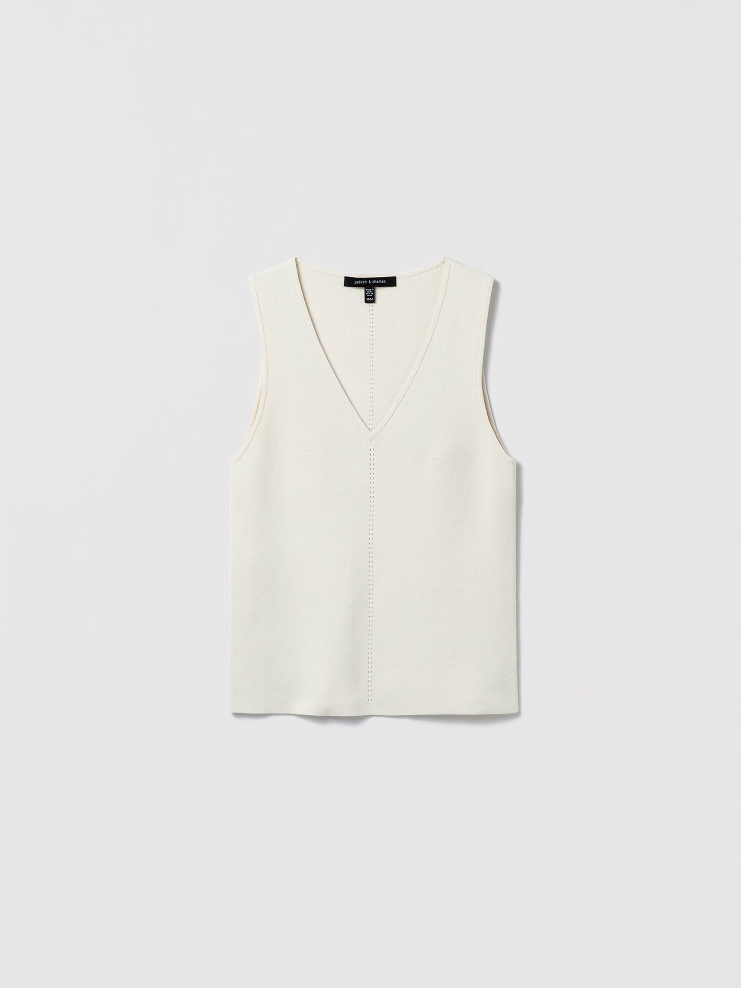 Flat‑lay of an off-white V‑neck silk‑cotton shell with clean lines and minimalist finishing.