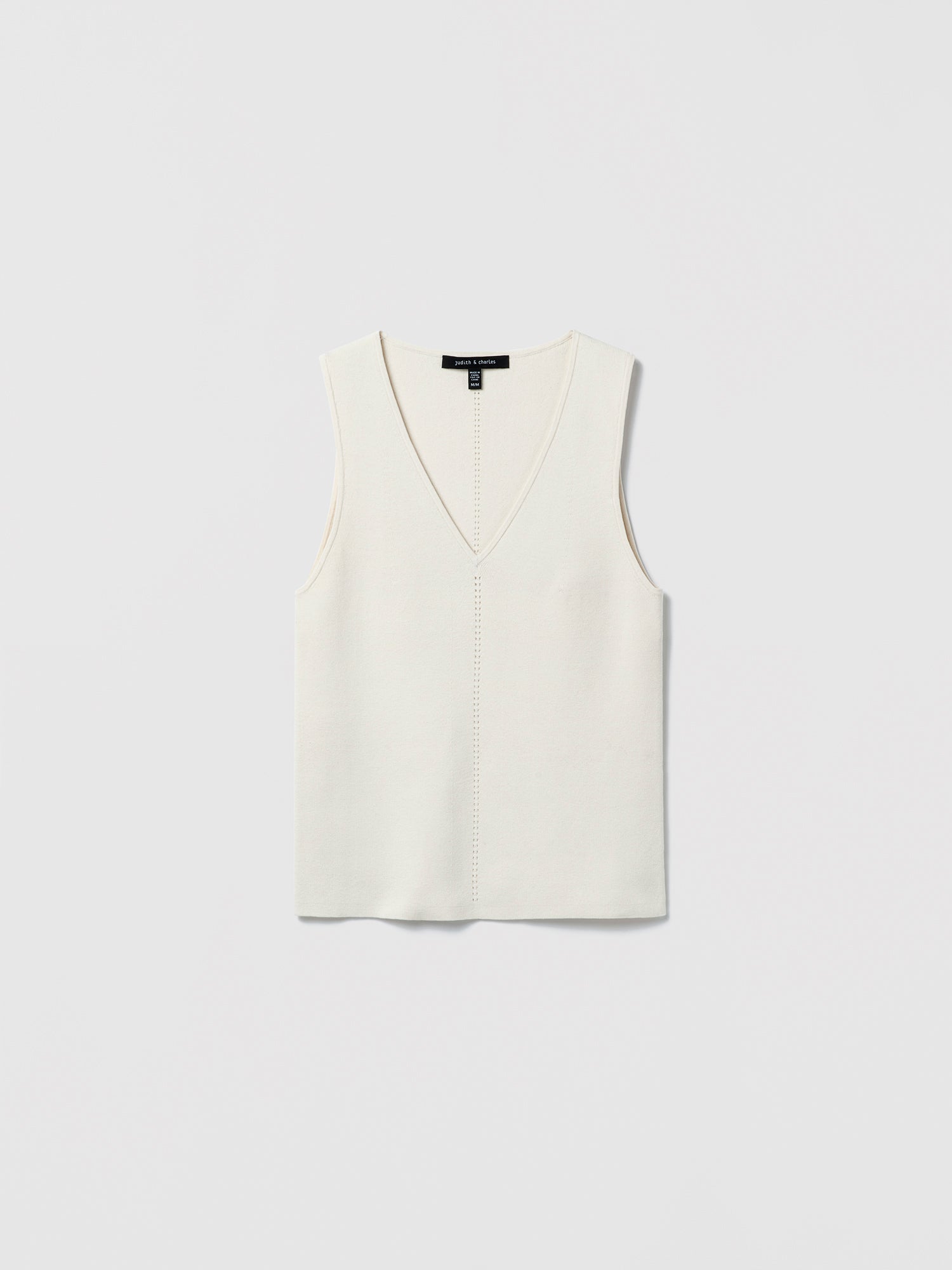 Flat‑lay of an off-white V‑neck silk‑cotton shell with clean lines and minimalist finishing.