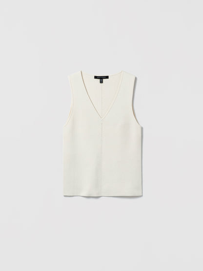 Flat‑lay of an off-white V‑neck silk‑cotton shell with clean lines and minimalist finishing.