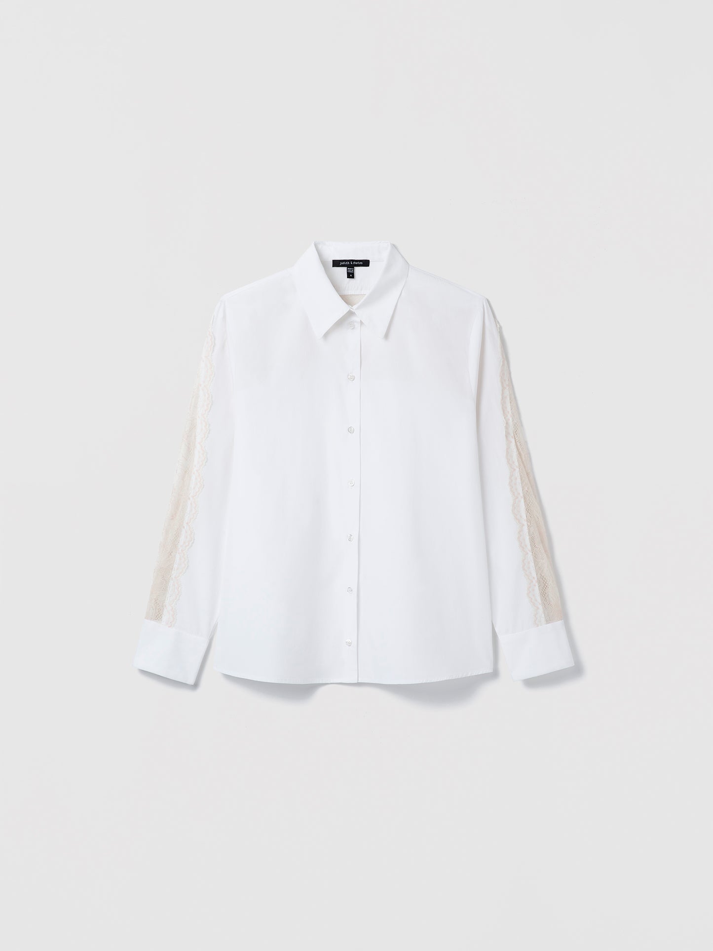 White shirt with sheer sleeves on a light gray background