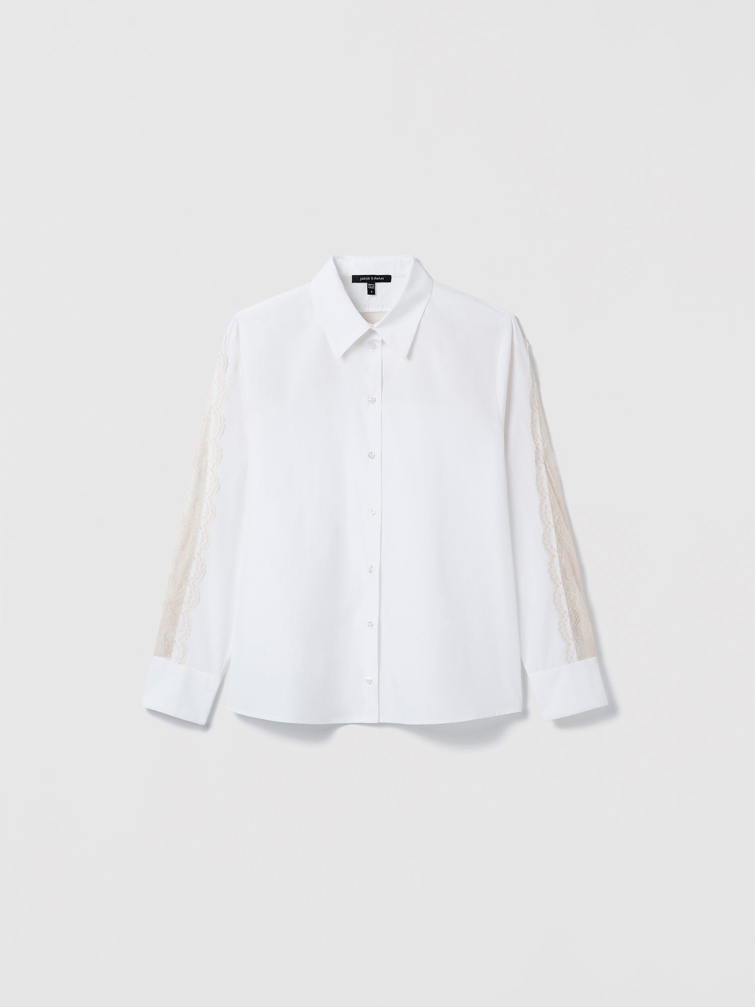 White shirt with sheer sleeves on a light gray background